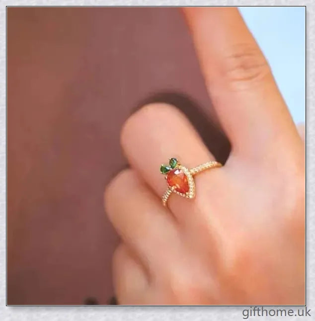 A close-up image of a charming copper ring with a carrot-shaped design and delicate micro-inlaid detailing.