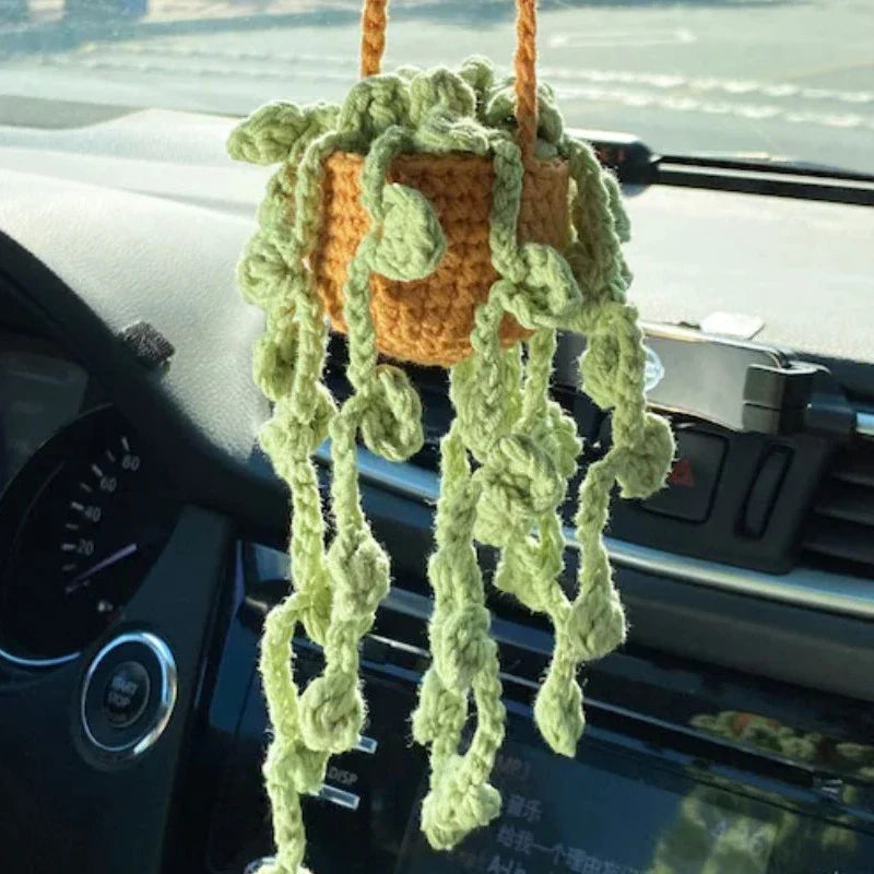 Charming knitted car plant decor with hanging white rope and green and white colour scheme