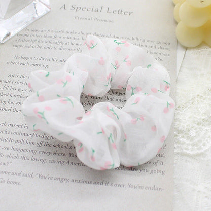 Handmade floral elastic hair bands with soft chiffon fabric and vibrant embroidered daisy patterns, perfect for enhancing everyday style in the UK.