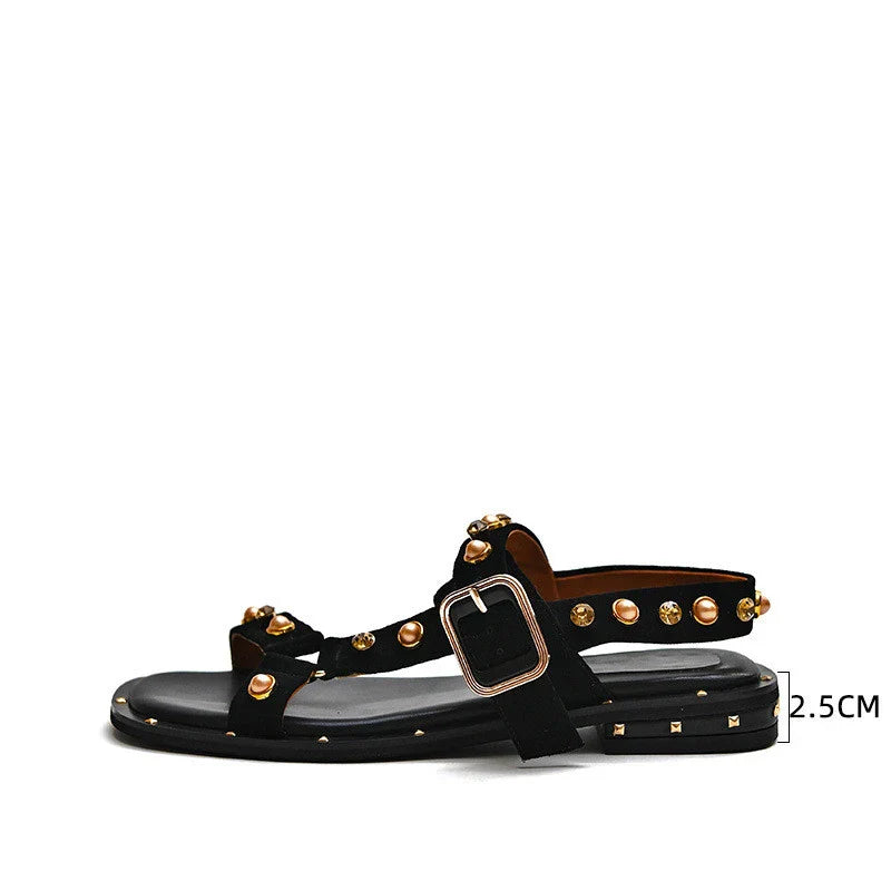 Black flat sandals with orange accents, inspired by the Roman Holiday style, suitable for women