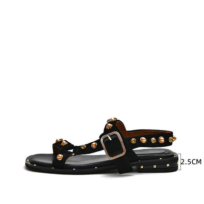 Black flat sandals with orange accents, inspired by the Roman Holiday style, suitable for women