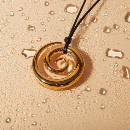 Exquisite spiral circle pendant necklace with 18K gold plating and black rope chain, a versatile accessory for the modern British woman.