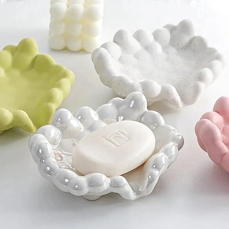 A ceramic soap dish with a whimsical cloud design, perfect for elevating your bathroom decor.