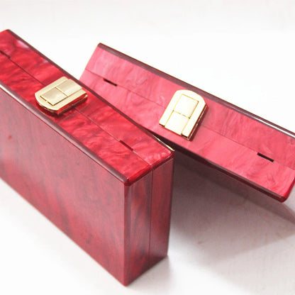 Stylish pearlescent acrylic clutch bag in red colour with a structured, square-shaped design