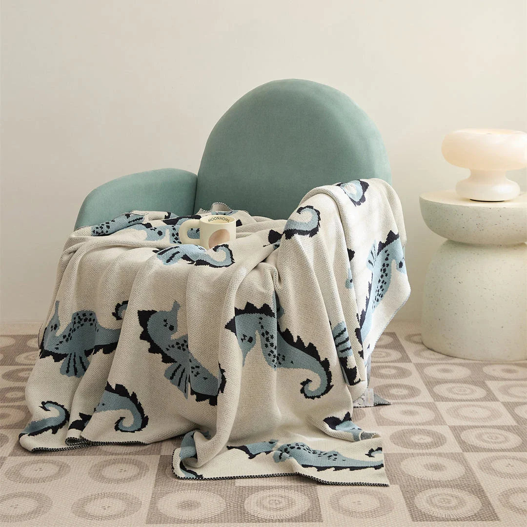 Soft and cosy 100% cotton blanket with a charming sea horse design, perfect for relaxation at home or on the go.