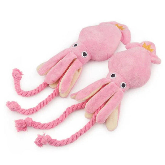 A soft, plush pink squid-shaped dog toy with a vibrant and whimsical design