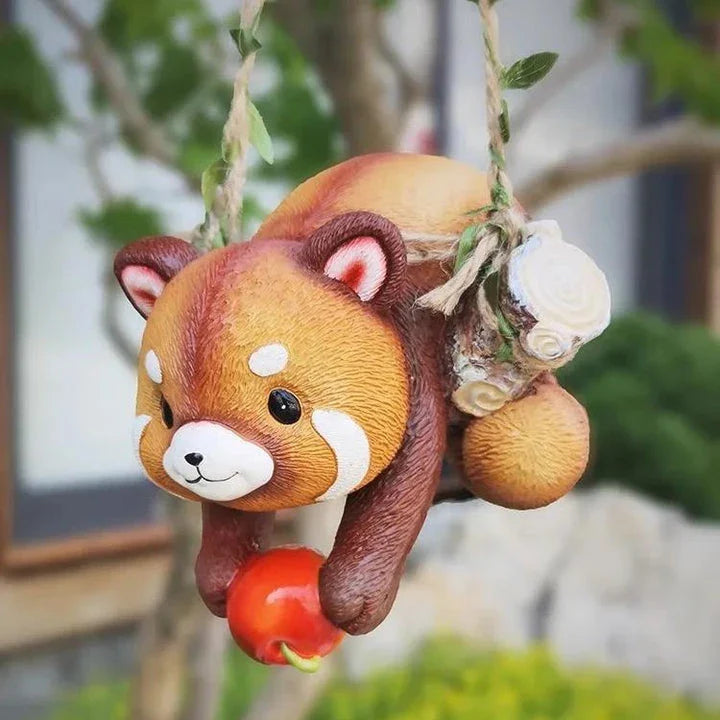 Charming resin raccoon statue climbing a decorative rope, adding a whimsical and nature-inspired touch to your outdoor or indoor spaces