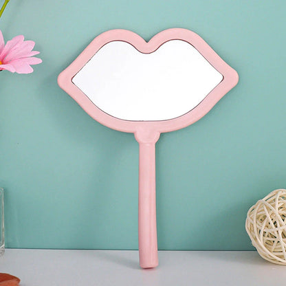 Lip-shaped handheld makeup mirror with a comfortable ergonomic handle for precise on-the-go touch-ups