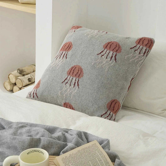 Elegant knitted cotton cushion cover featuring a detailed embroidered jellyfish design, available in grey and green colours.