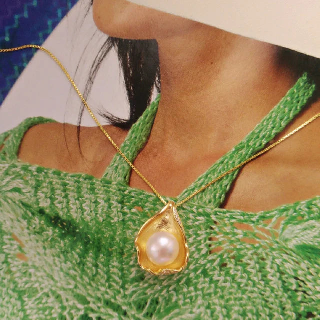 Elegant pearl pendant necklace with sterling silver setting, featuring a modern geometric design