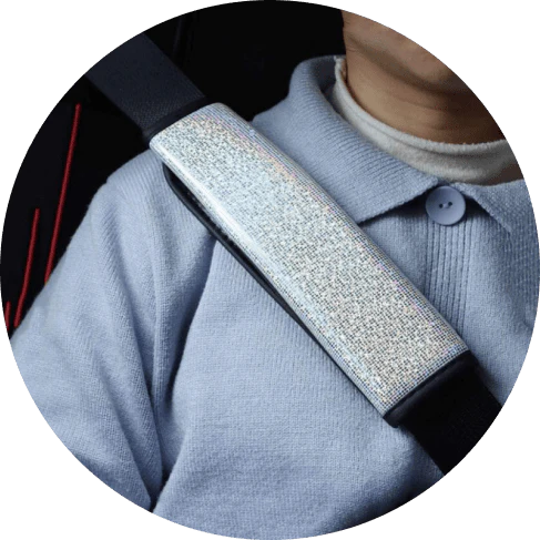 Multicoloured bling seat belt covers in a car, adding a touch of glamour and personality to the interior