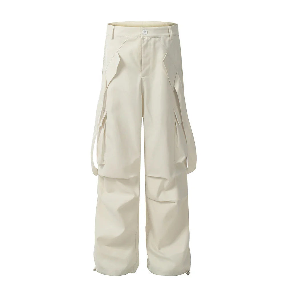 Stylish black pleated overalls with ribbon pockets, a versatile and refined menswear piece.