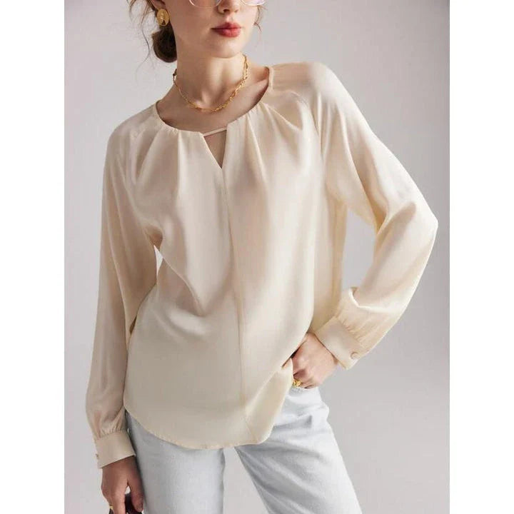 Elegant silk-blend blouse with raglan sleeves, featuring a timeless design and unique hollow-out details