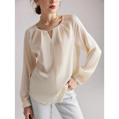 Elegant silk-blend blouse with raglan sleeves, featuring a timeless design and unique hollow-out details
