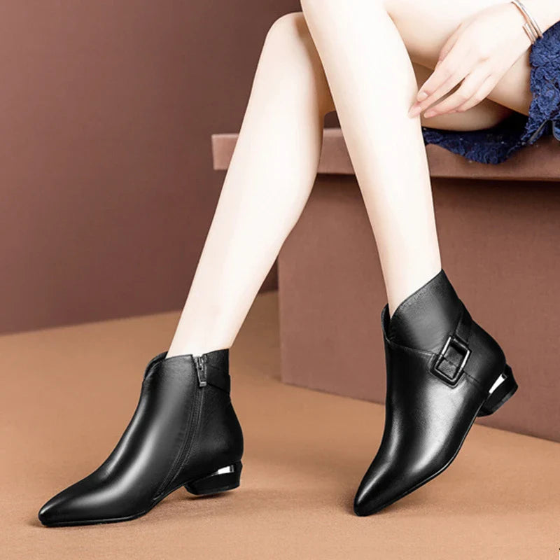 Premium low-heel short-tube ladies fashion boots in black and dark brown colours, featuring a sleek pointed toe and subtly profiled heel design