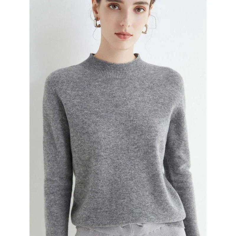 A woman wearing a luxurious Merino wool mock-neck jumper in a stylish autumnal outfit