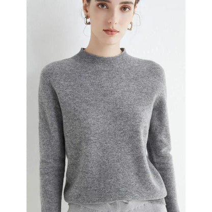 A woman wearing a luxurious Merino wool mock-neck jumper in a stylish autumnal outfit