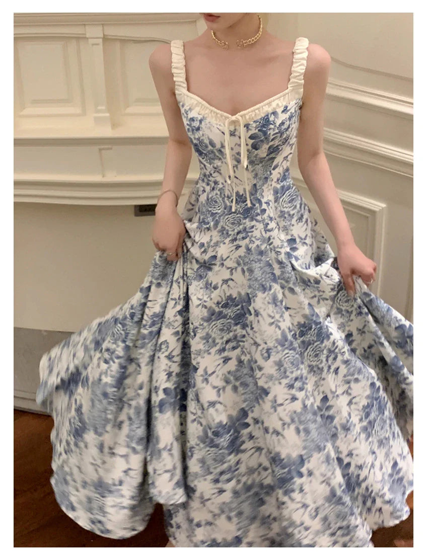 Elegant floral print dress with adjustable straps, A-line silhouette, and high-waisted design for a timeless British fashion look.