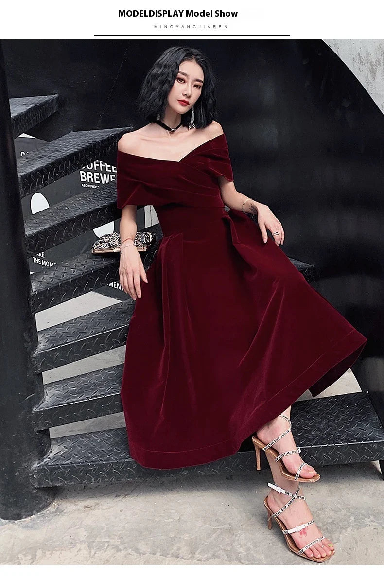 Off-shoulder wine red bridal dress with long, flowing skirt and tight waist for a sophisticated, elegant look