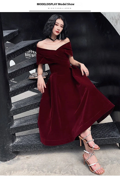 Off-shoulder wine red bridal dress with long, flowing skirt and tight waist for a sophisticated, elegant look