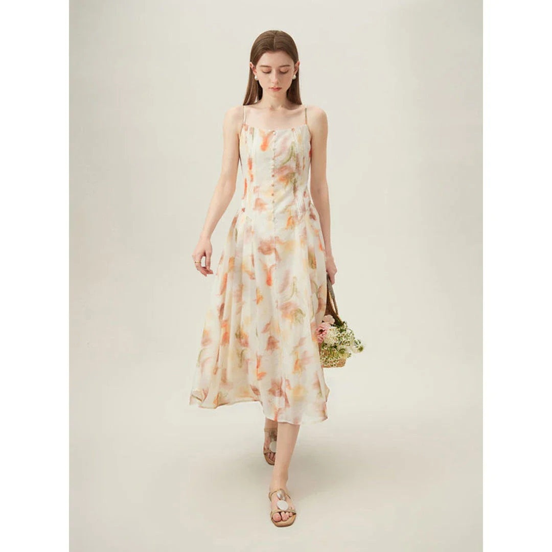 Floral sleeveless summer dress with A-line silhouette and vibrant orange print, perfect for British summer occasions