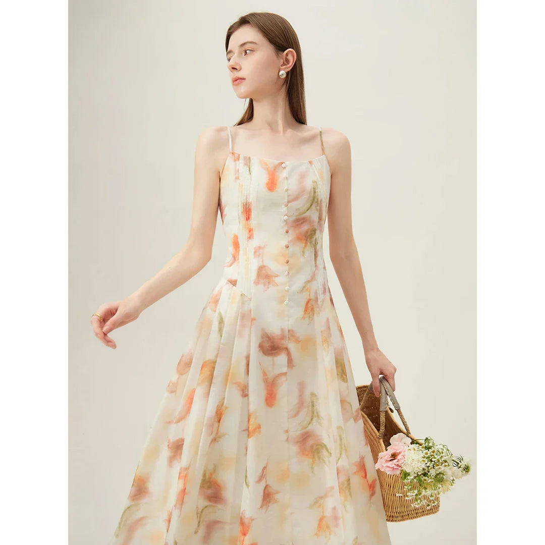 Floral sleeveless summer dress with A-line silhouette and vibrant orange print, perfect for British summer occasions