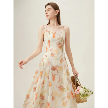 Floral sleeveless summer dress with A-line silhouette and vibrant orange print, perfect for British summer occasions