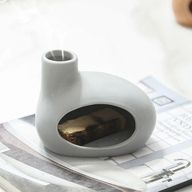 Elegant ceramic tabletop incense burner with Palo Santo wood aroma, available in light brown, white, and grey colours
