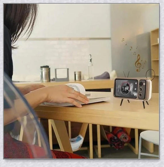 Retro TV-inspired phone stand with built-in Bluetooth speaker for hands-free entertainment and music playback