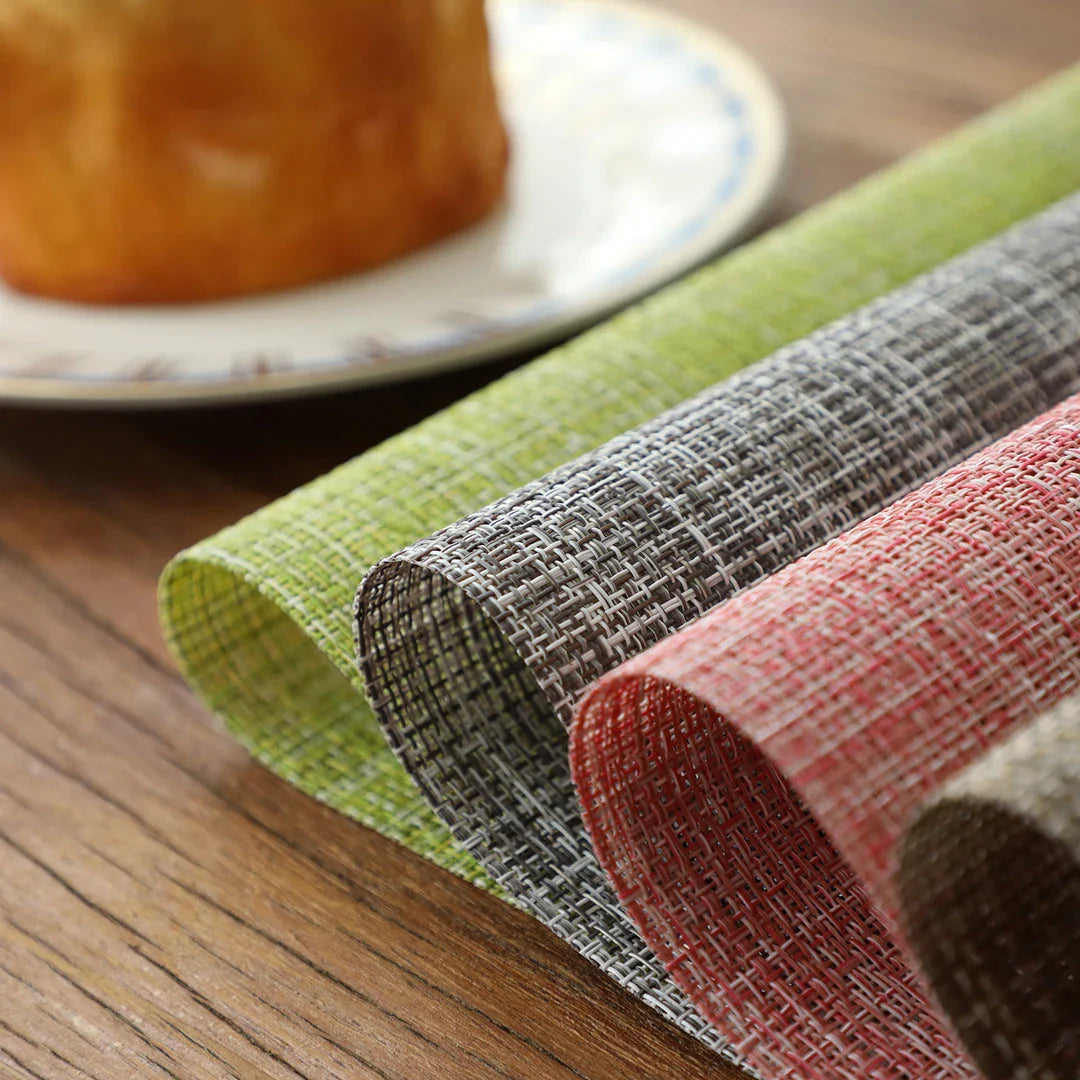 Stylish and durable waterproof placemats in black, protecting a dining table from spills and stains