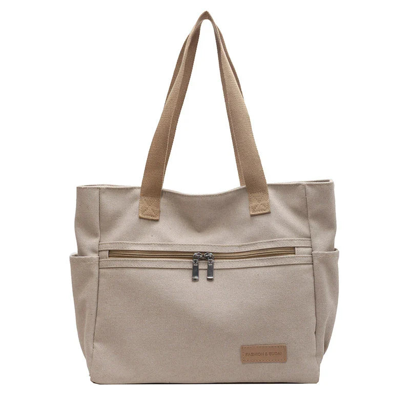 Premium canvas shoulder bag in grey, khaki, and green colours, featuring a stylish and functional design for everyday use.