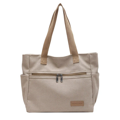 Premium canvas shoulder bag in grey, khaki, and green colours, featuring a stylish and functional design for everyday use.