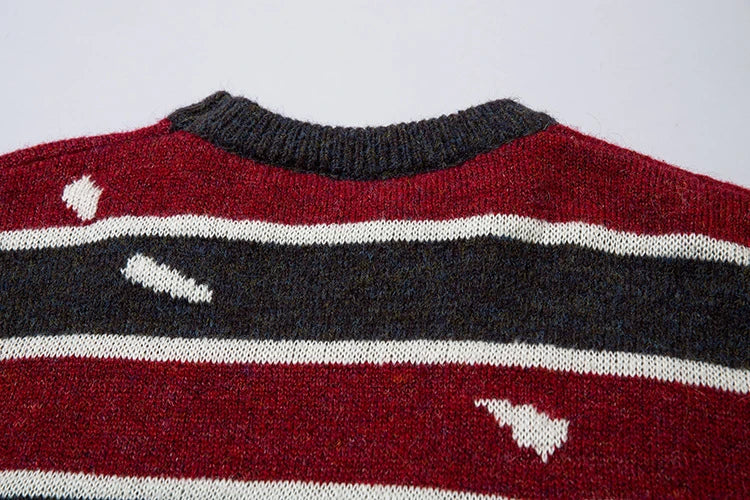 A cosy and stylish jumper featuring a patchwork design with contrasting stripes in a classic British colour palette.