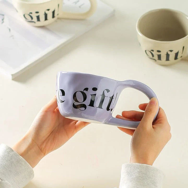 Handcrafted creative alphabet ceramic mug in beige, purple, and khaki colours for hot drinks like coffee and tea