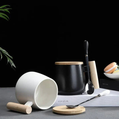 A stylish ceramic coffee mug with a colour block design and a coordinating wooden spoon
