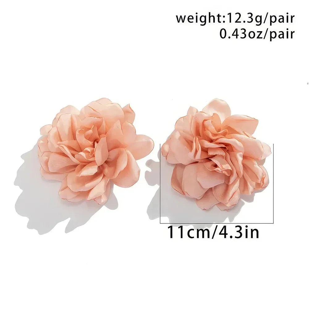 Exquisite fluffy fabric flower stud earrings in a black metal colour, featuring oversized fabric blooms for a unique and elegant design.