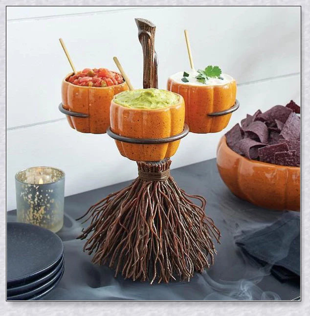 Pumpkin-shaped snack bowls on a broom-inspired stand, perfect for Halloween parties and displays