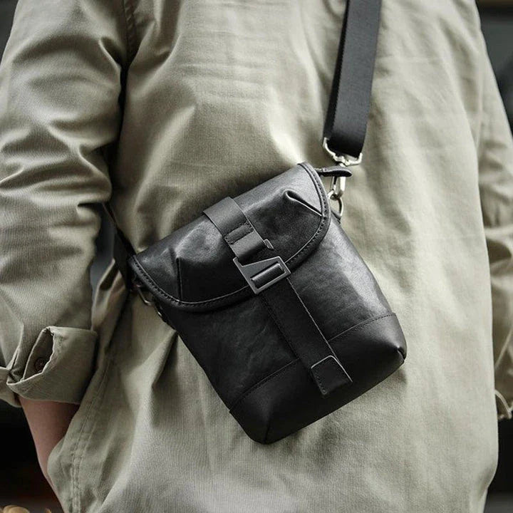Premium cowhide leather shoulder sling bag with one-shoulder design and oblique paneling for modern British style