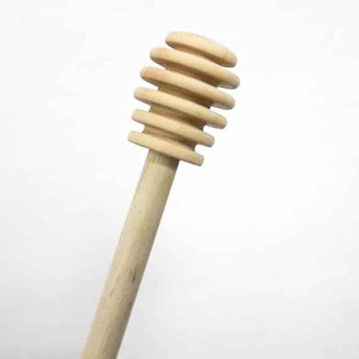 Handcrafted wooden honey spoon with a natural beeswax finish, showcasing the elegant design and timeless British craftsmanship.