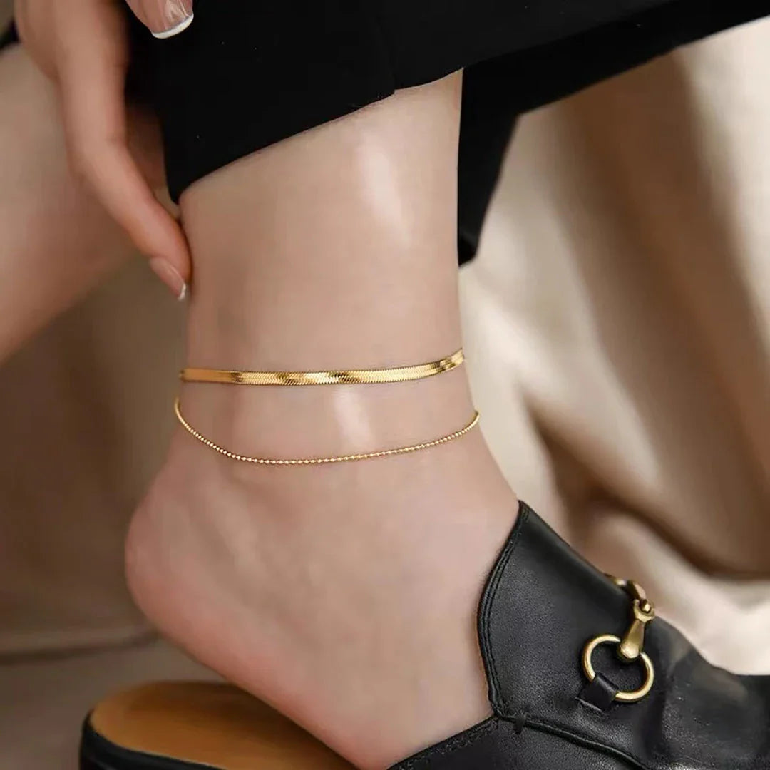 Exquisite 18K gold-plated double layer snake chain anklet with a durable stainless steel base, designed to elevate summer style with timeless elegance.