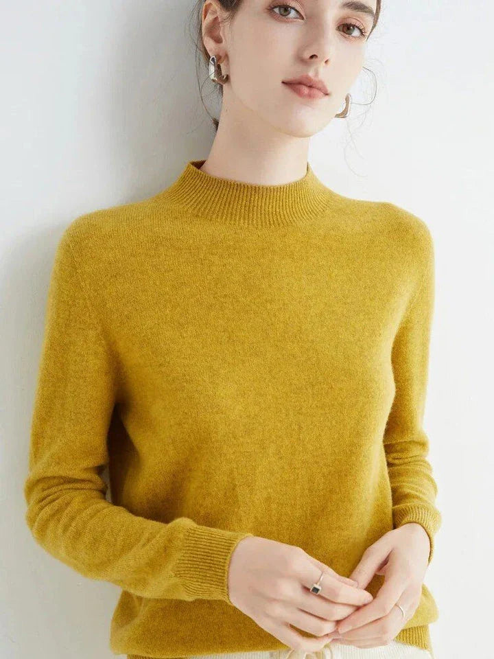 A woman wearing a luxurious Merino wool mock-neck jumper in a stylish autumnal outfit