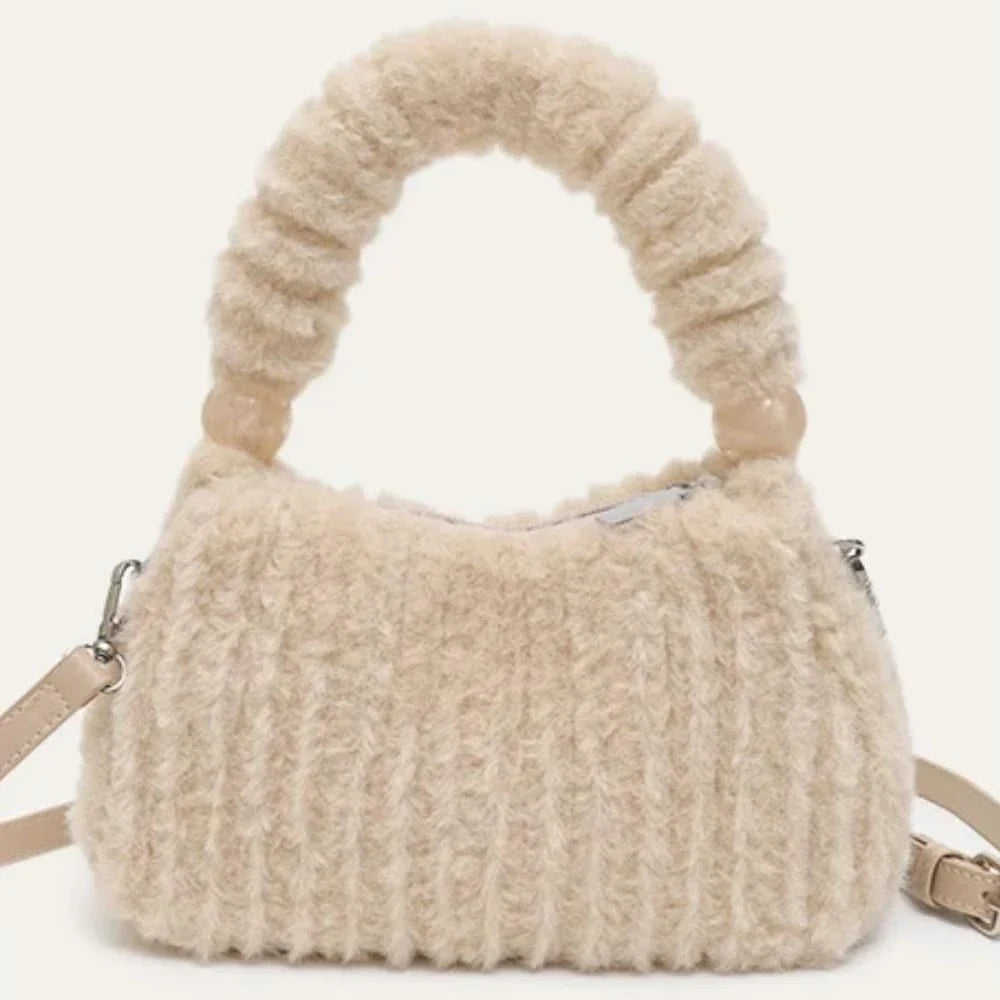 A luxurious faux fur hobo handbag with a stylish baguette shape and secure zipper closure