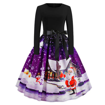 A festive, vintage-inspired Christmas dress with a vibrant retro print, flowing swing skirt, and long sleeves for a timeless, feminine look.