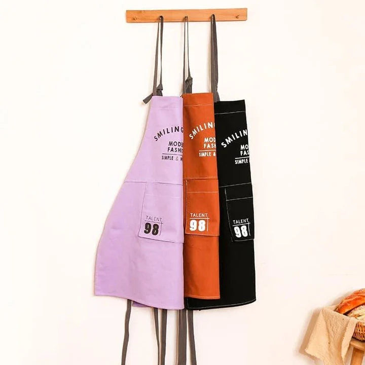 A stylish and practical Nordic-inspired canvas barista apron with a spacious front pocket and adjustable neck strap for a comfortable fit.