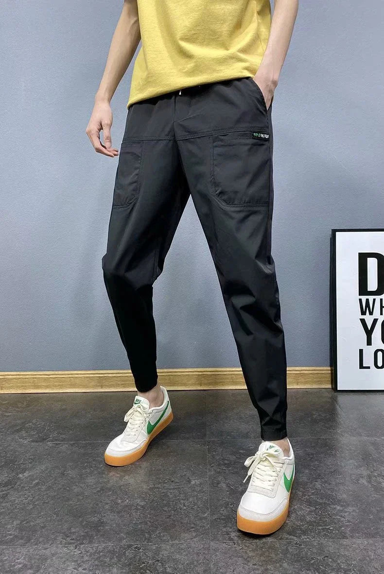 Premium slim-fit drawstring joggers in black and grey, featuring a tailored silhouette and adjustable waistband for a polished, comfortable look.