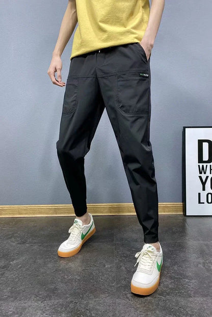 Premium slim-fit drawstring joggers in black and grey, featuring a tailored silhouette and adjustable waistband for a polished, comfortable look.