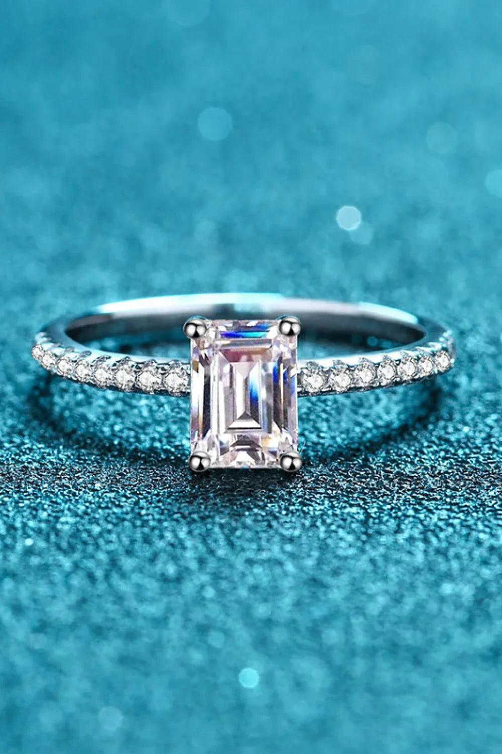 Exquisite 925 sterling silver ring with a radiant moissanite centre stone, accented with sparkling zircon stones for added elegance.
