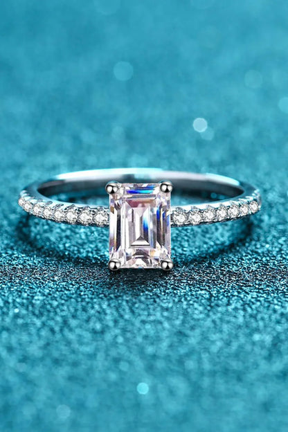 Exquisite 925 sterling silver ring with a radiant moissanite centre stone, accented with sparkling zircon stones for added elegance.