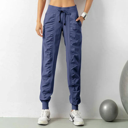 Premium women's sports trousers with drawstring waist and pockets, made of high-quality nylon fabric for comfort and versatility.