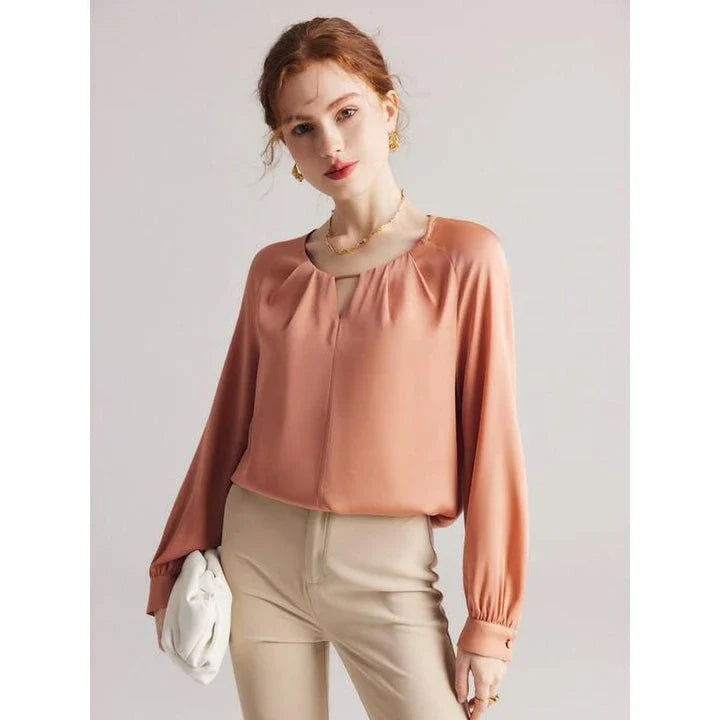 Elegant silk-blend blouse with raglan sleeves, featuring a timeless design and unique hollow-out details